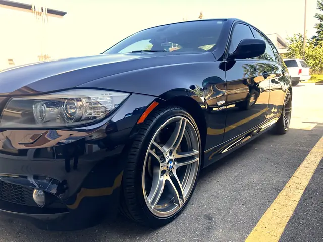 Black BMW 3 Series with a glossy finish and clean wheels