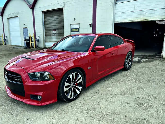 Red Dodge Charger SRT with a clean, glossy finish, front three-quarter view