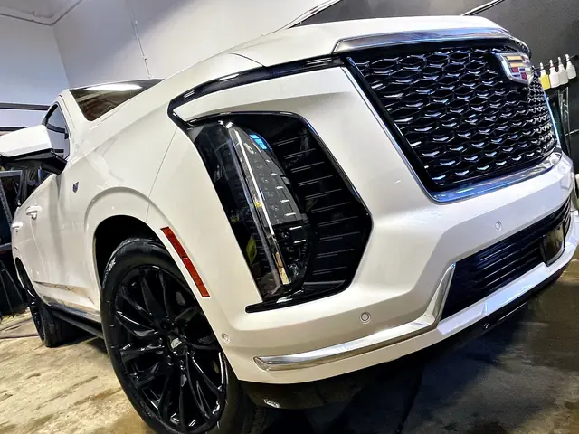 White Cadillac Escalade, close view of the front end and grille