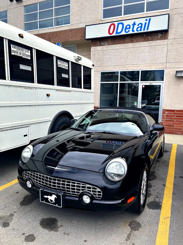 Black Ford Thunderbird convertible parked outside the O Detail shop in Airdrie