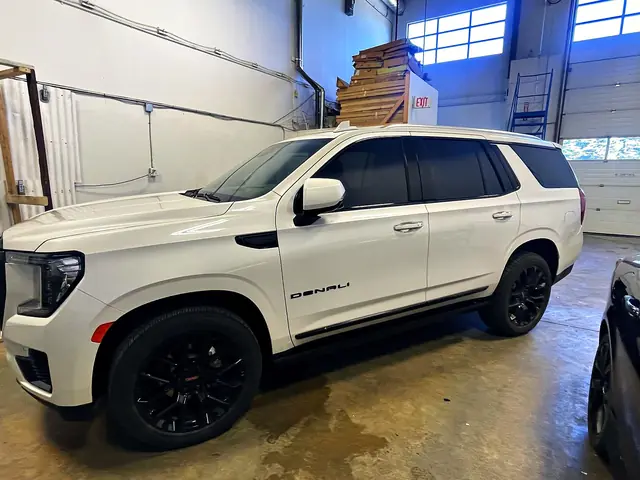 White GMC Yukon Denali with freshly tinted windows in the O Detail shop